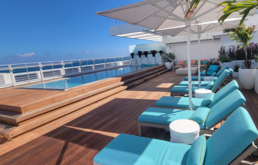 Luxurious rooftop Ipe deck with pool and turquoise loungers in San Diego